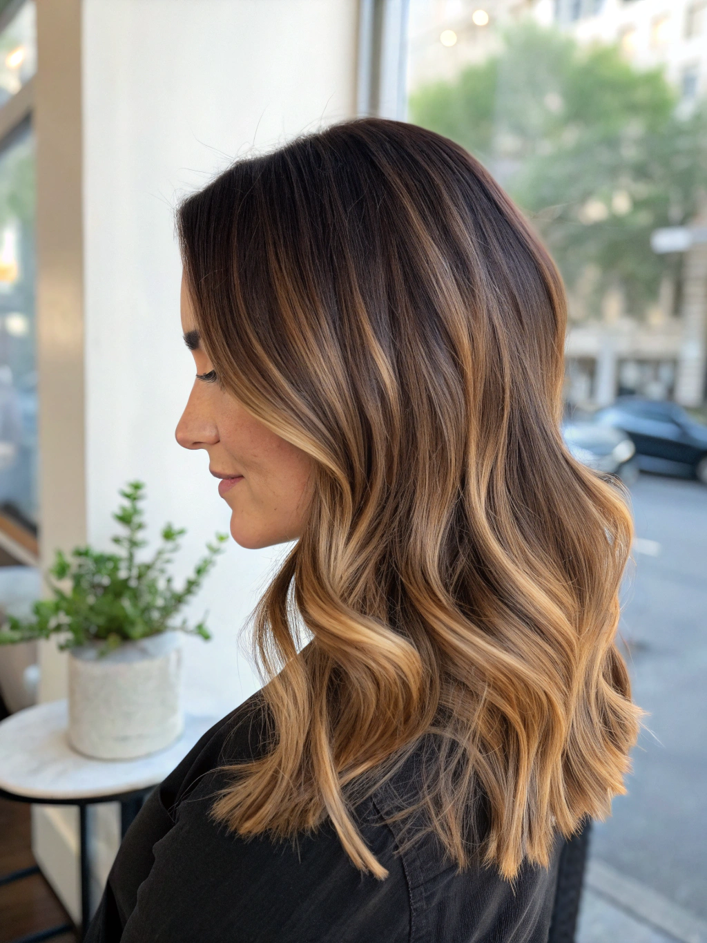 Soft sun-kissed balayage on long wavy hair